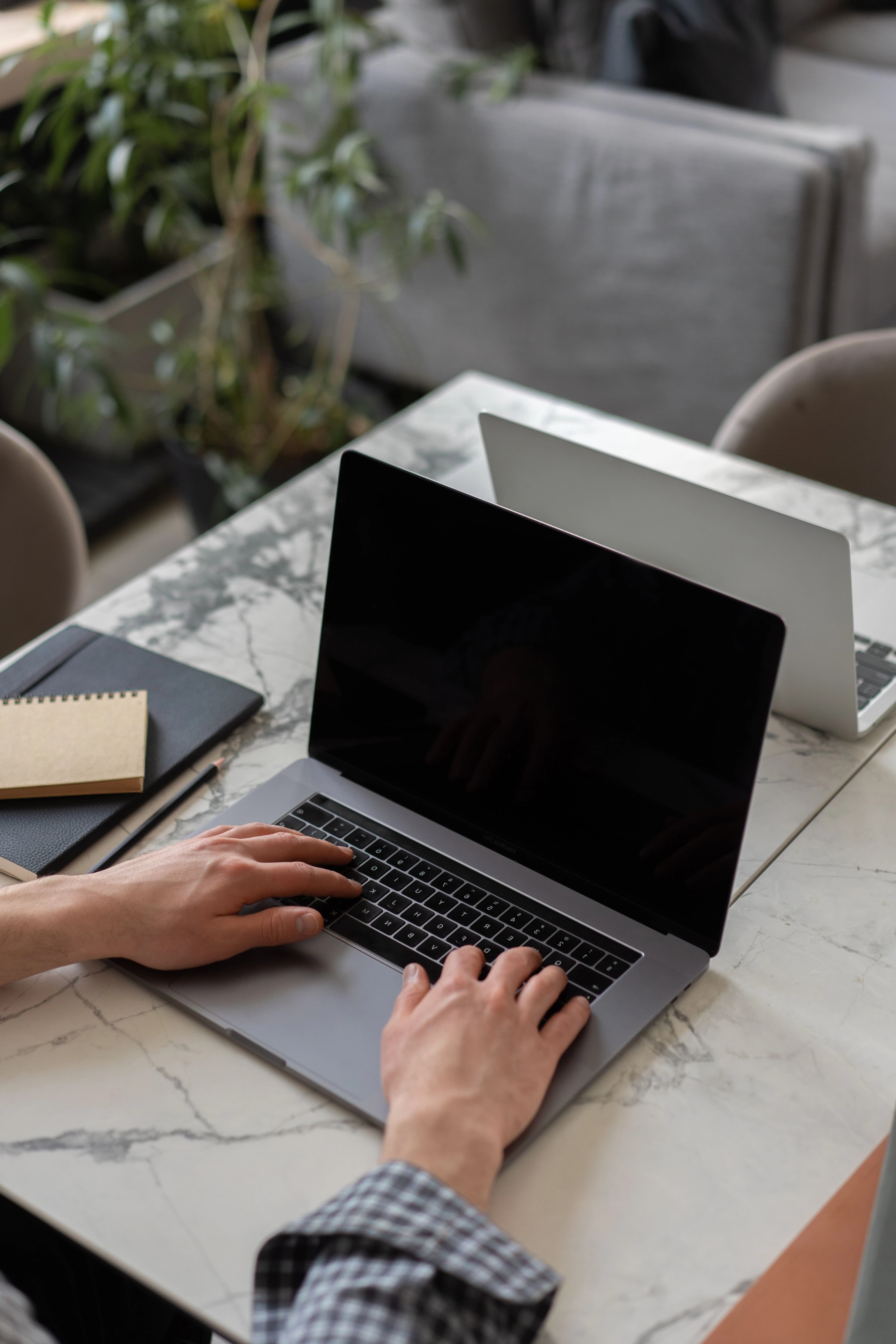 Notebook and laptop on a desk, planning before we build